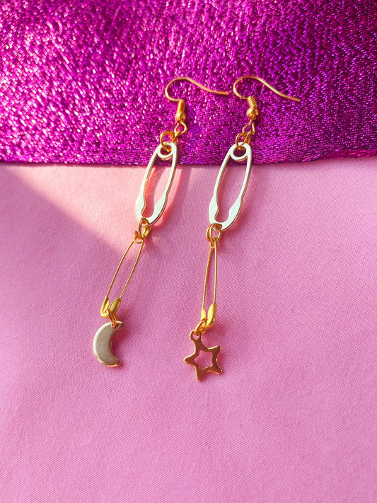 Gold safety pin with moon and star charm earrings Leftbians