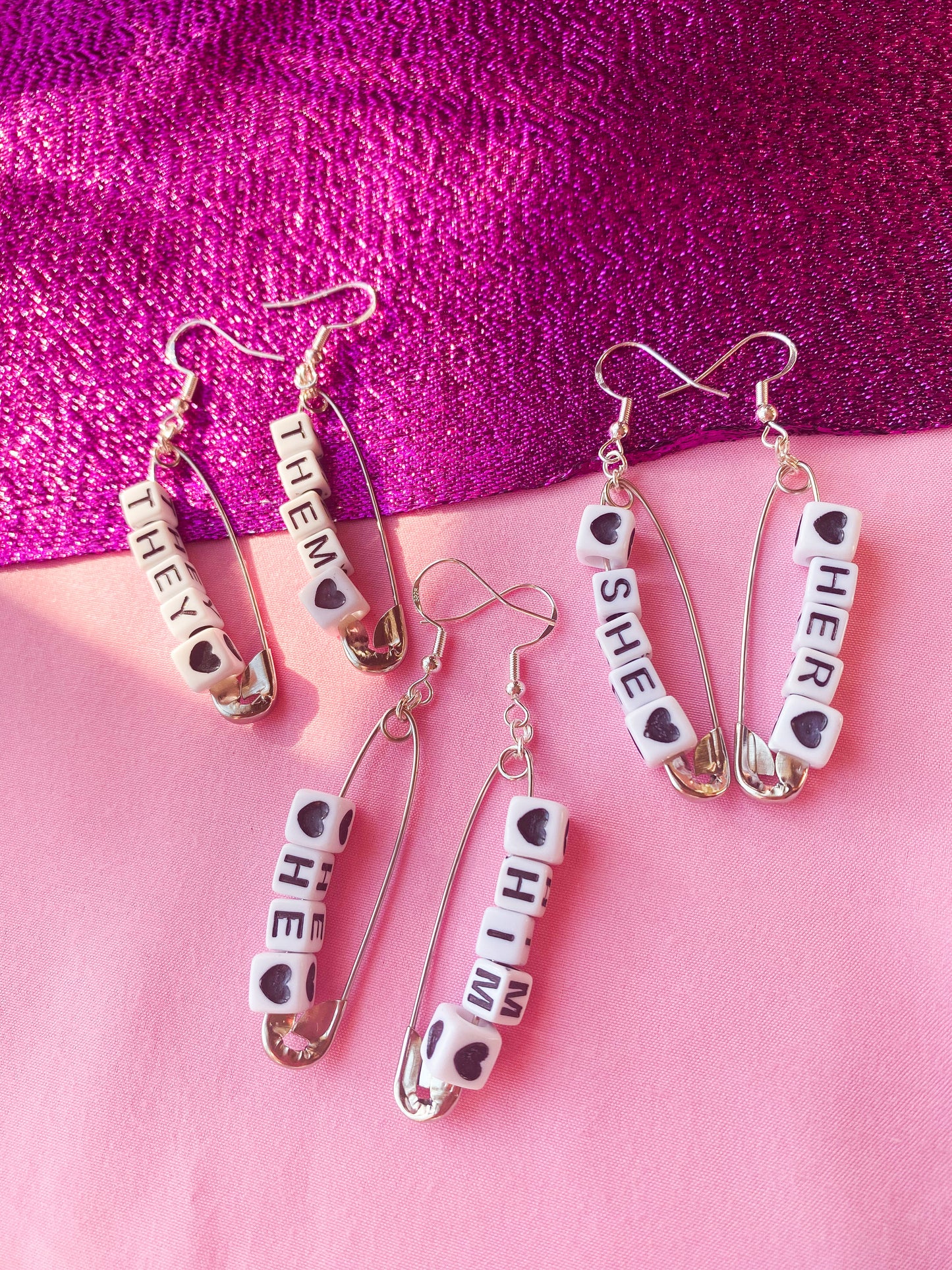 Silver safety pin pronoun earrings