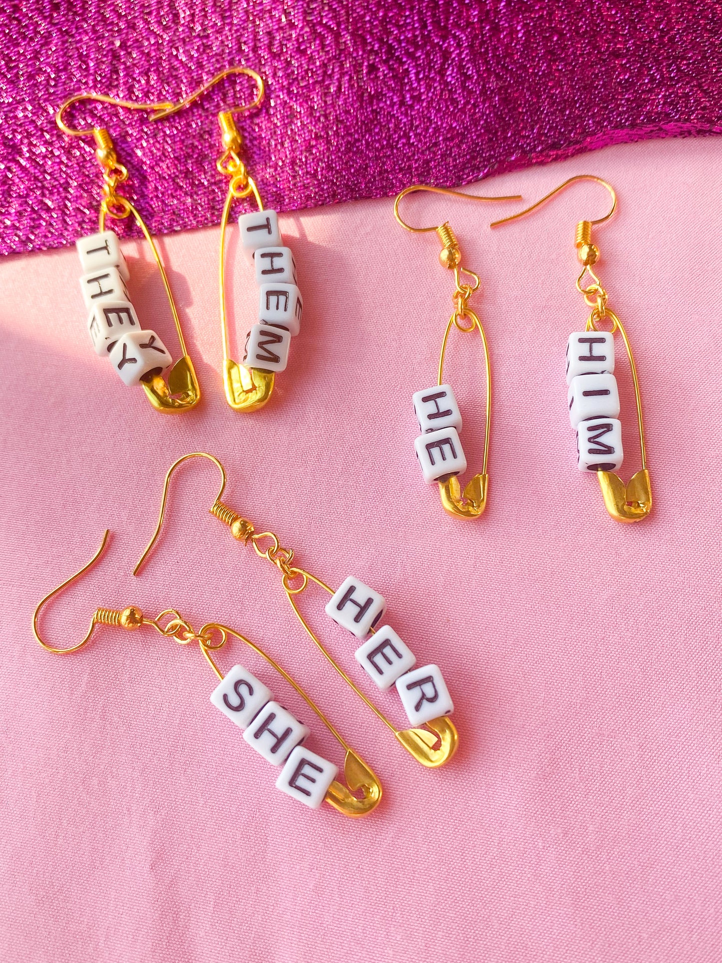 Gold safety pin pronoun earrings