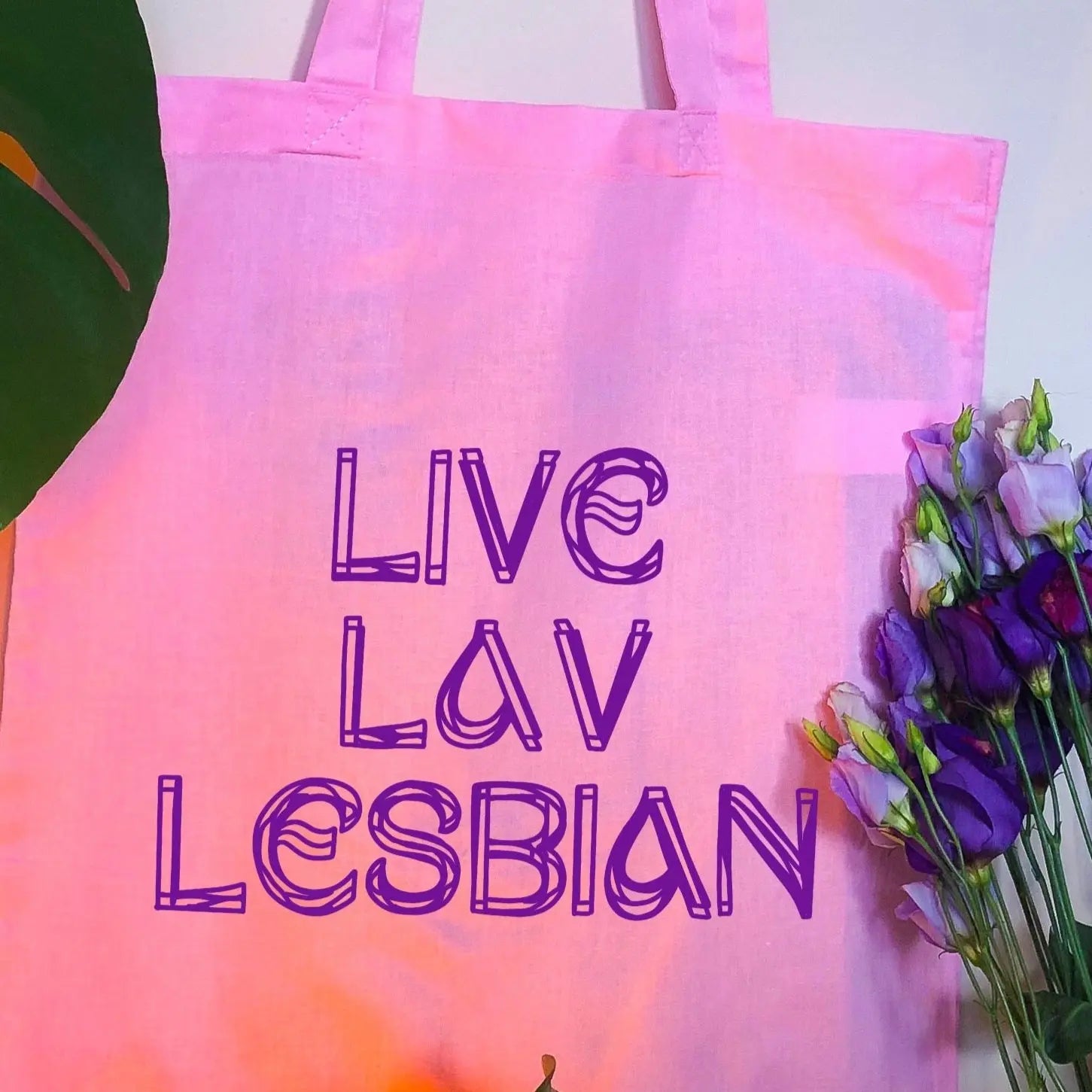 Live Lav Lesbian, pink tote bag with purple vinyl text. Leftbians Collab with Lavender Rodriguez Leftbians