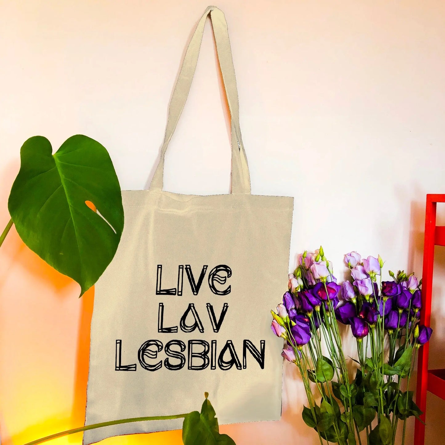 Live Lav Lesbian, Beige tote bag with black vinyl text. Leftbians Collab with Lavender Rodriguez Leftbians