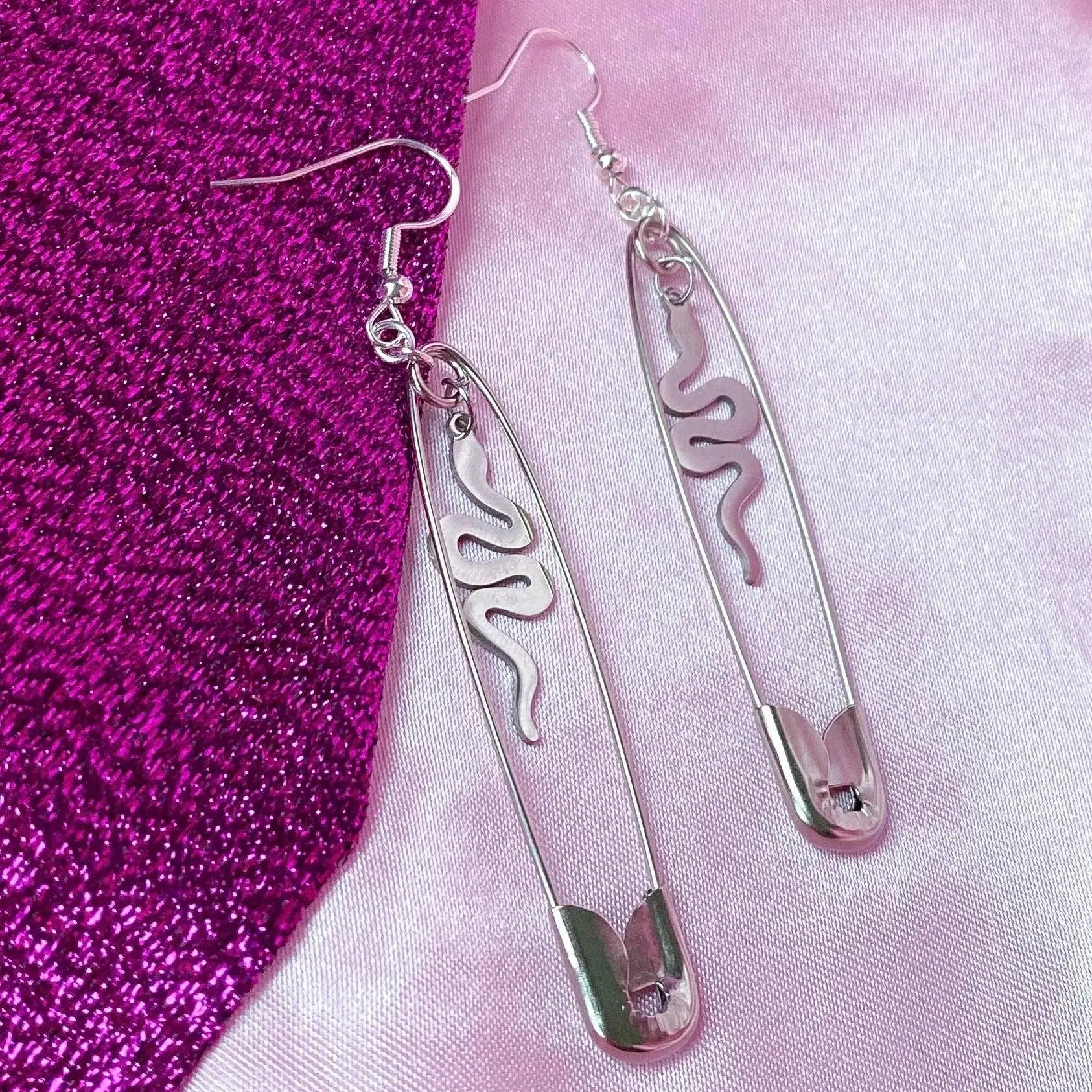 Safety pin earrings with snake charms Leftbians