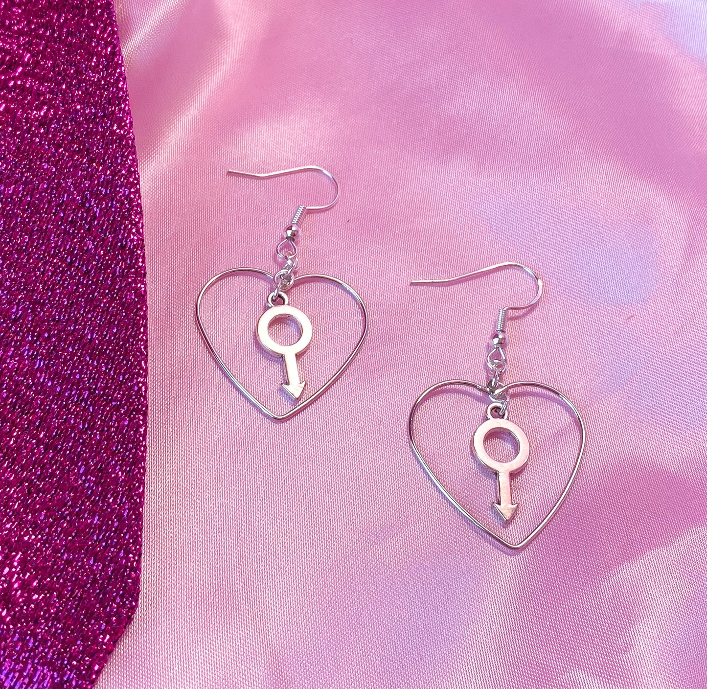 Silver colour heart and Mars charm earrings