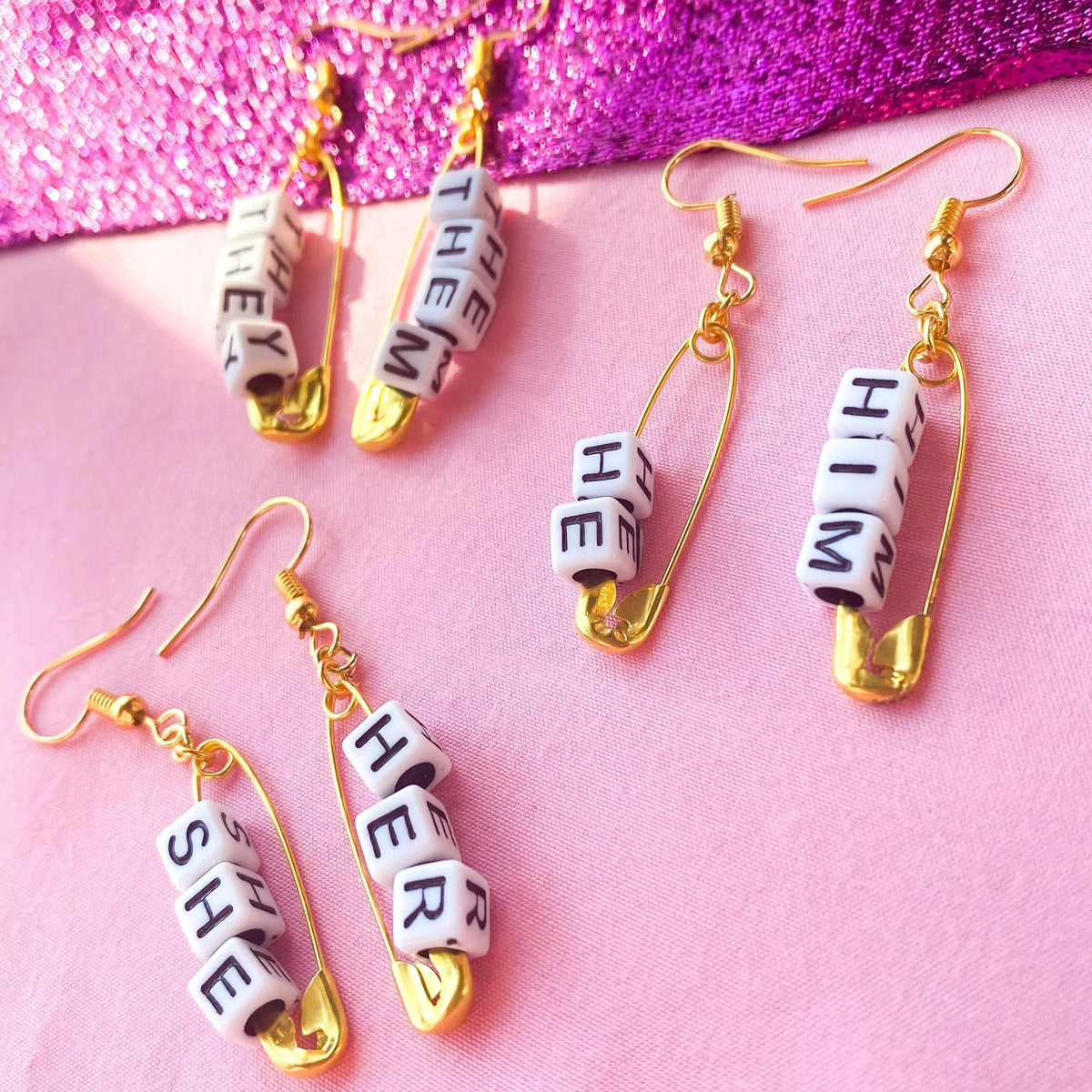 Gold safety pin pronoun earrings Leftbians