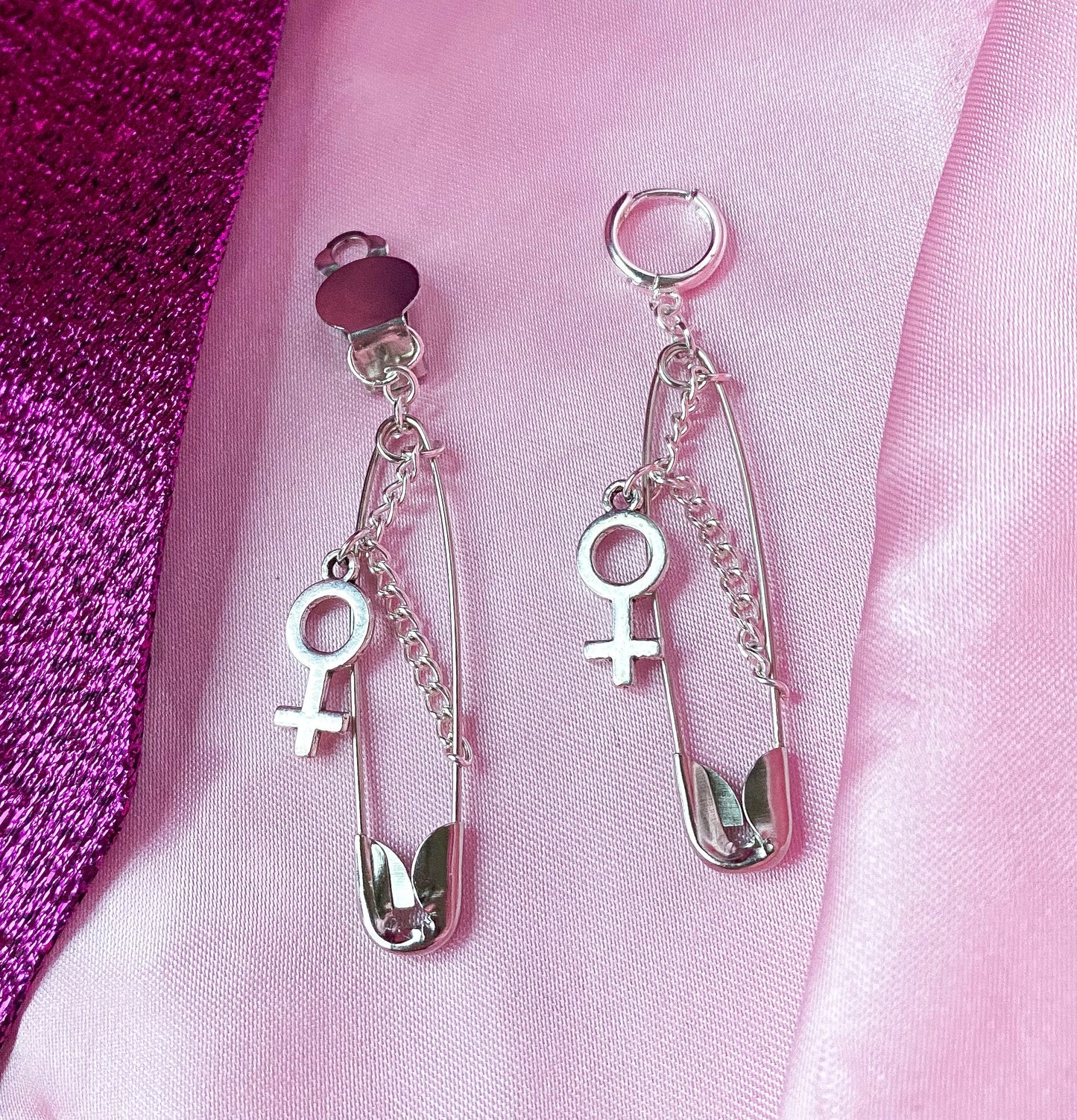 Safety pin earrings with Venus symbol charm