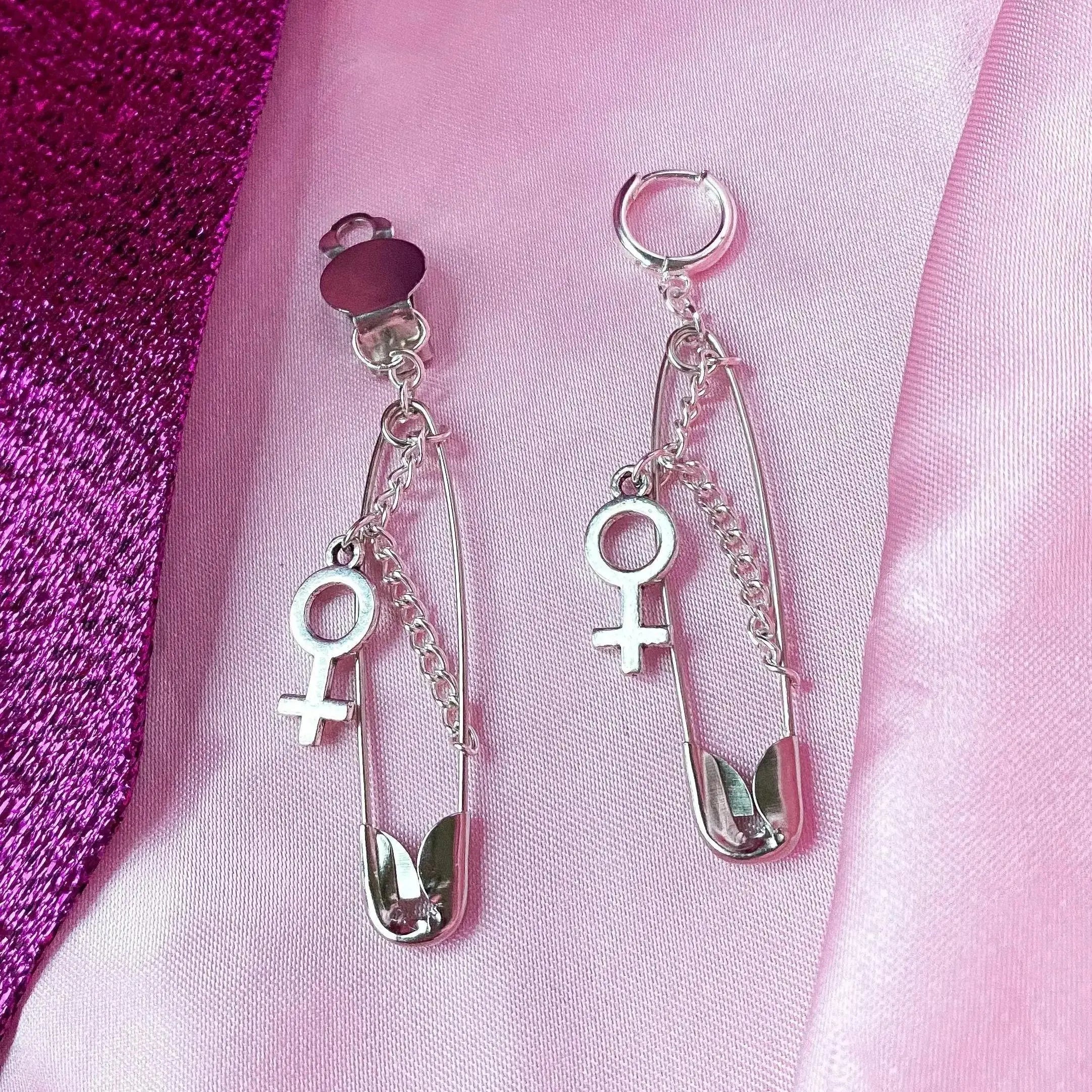 Safety pin earrings with Venus symbol charm Leftbians