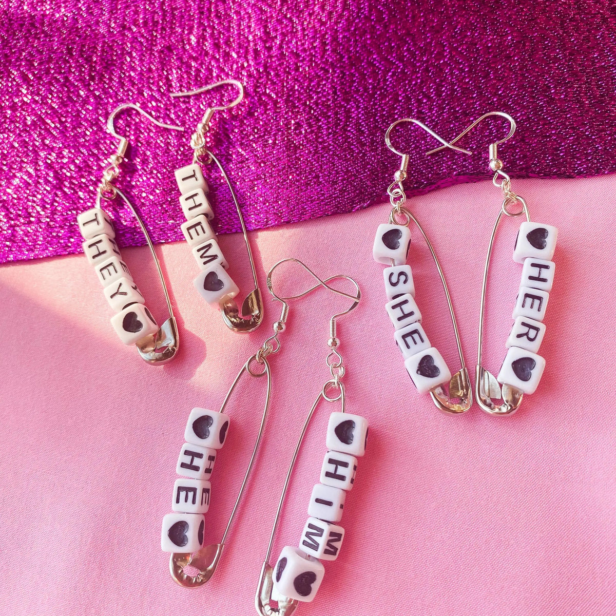 Silver safety pin pronoun earrings Leftbians