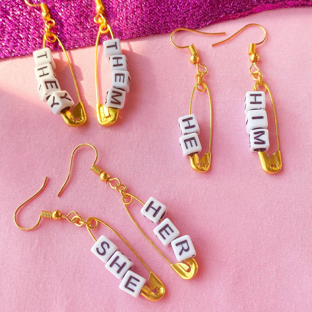Gold safety pin pronoun earrings Leftbians