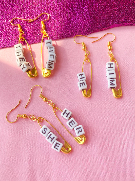 Gold safety pin pronoun earrings