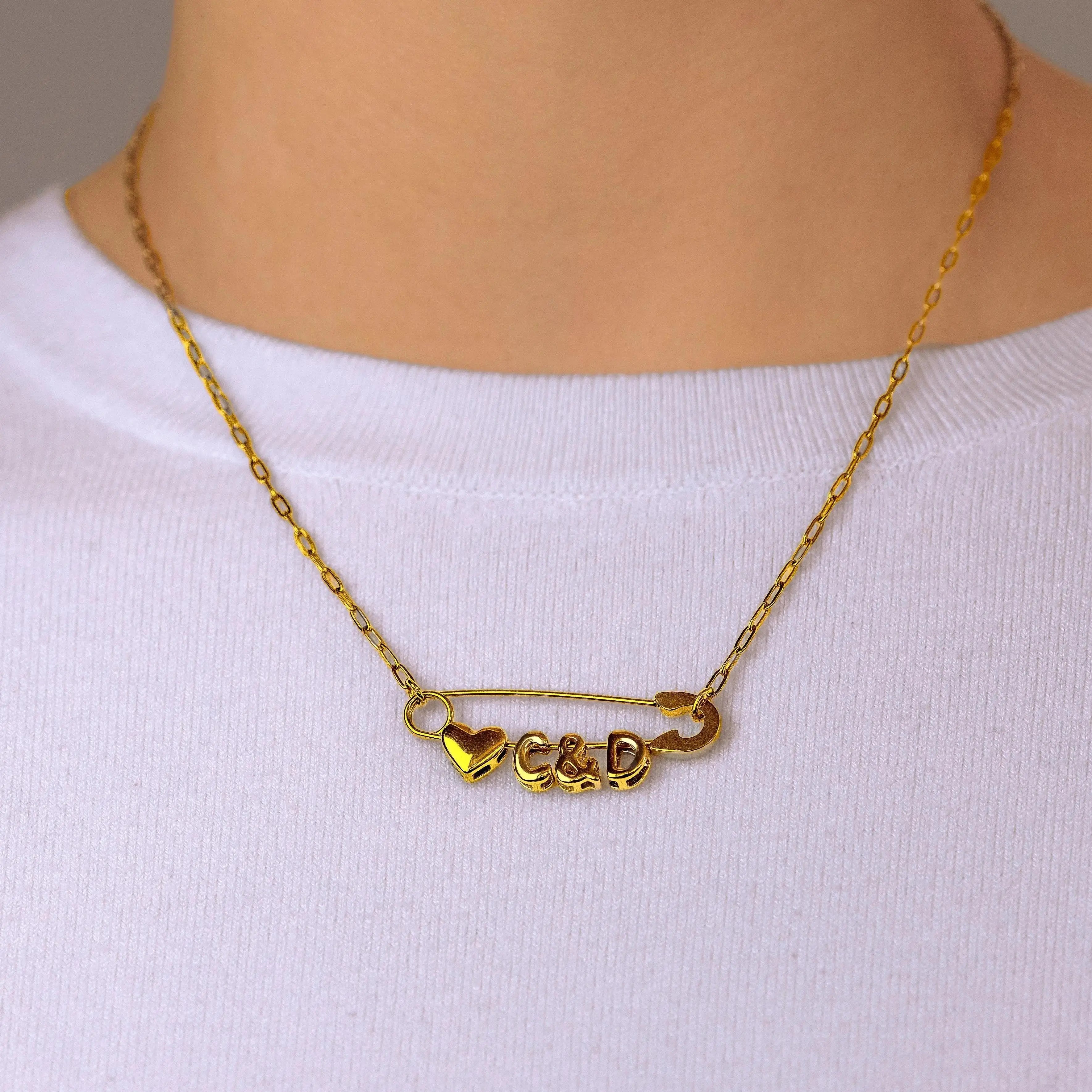 Gold safety pin couple heart necklace Leftbians