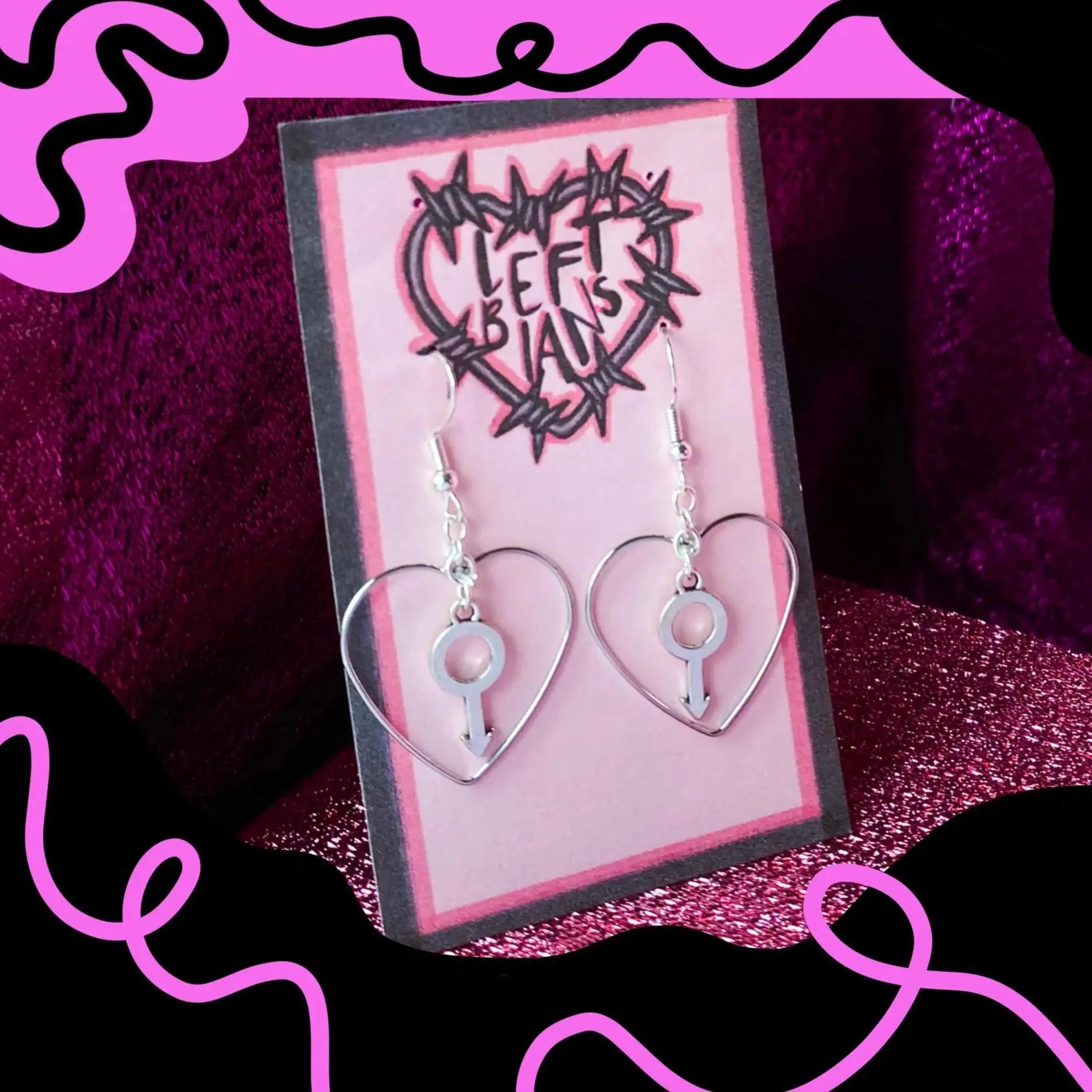 Silver colour heart and mars charm earrings Leftbians