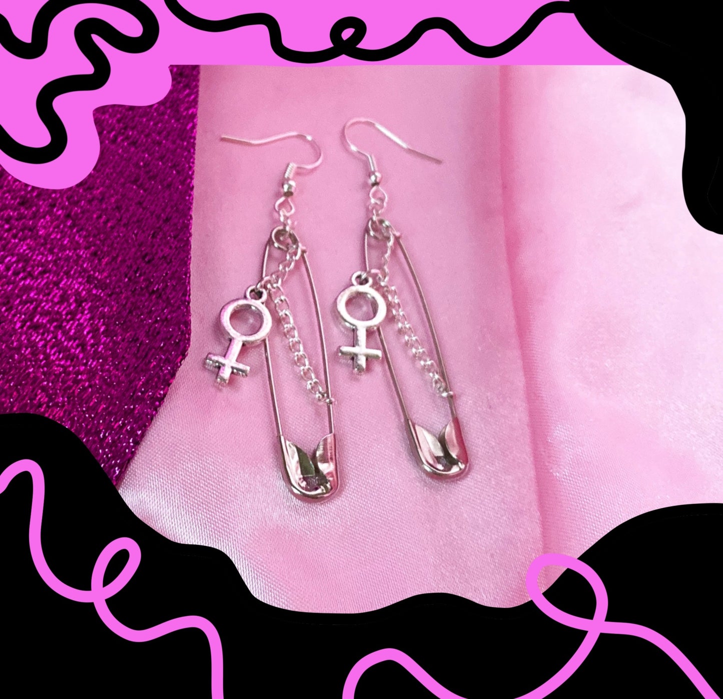 Safety pin earrings with Venus symbol charm