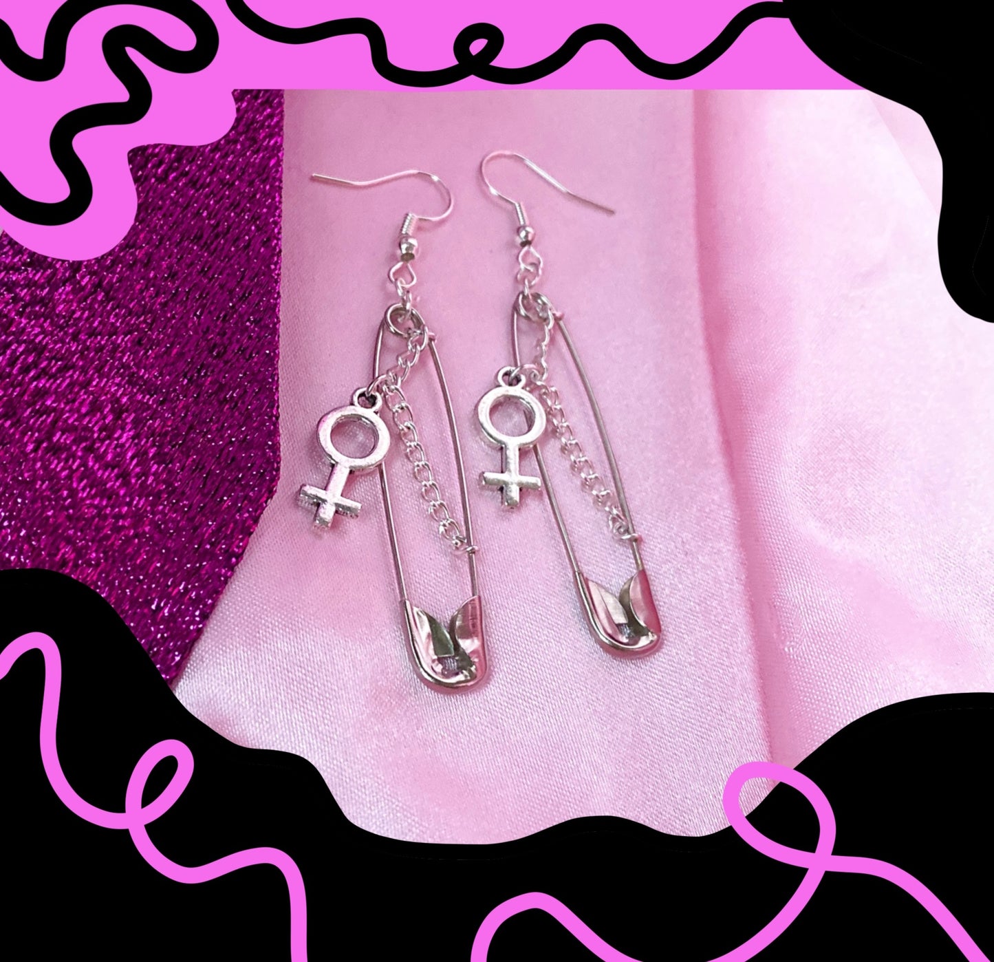 Safety pin earrings with Venus symbol charm