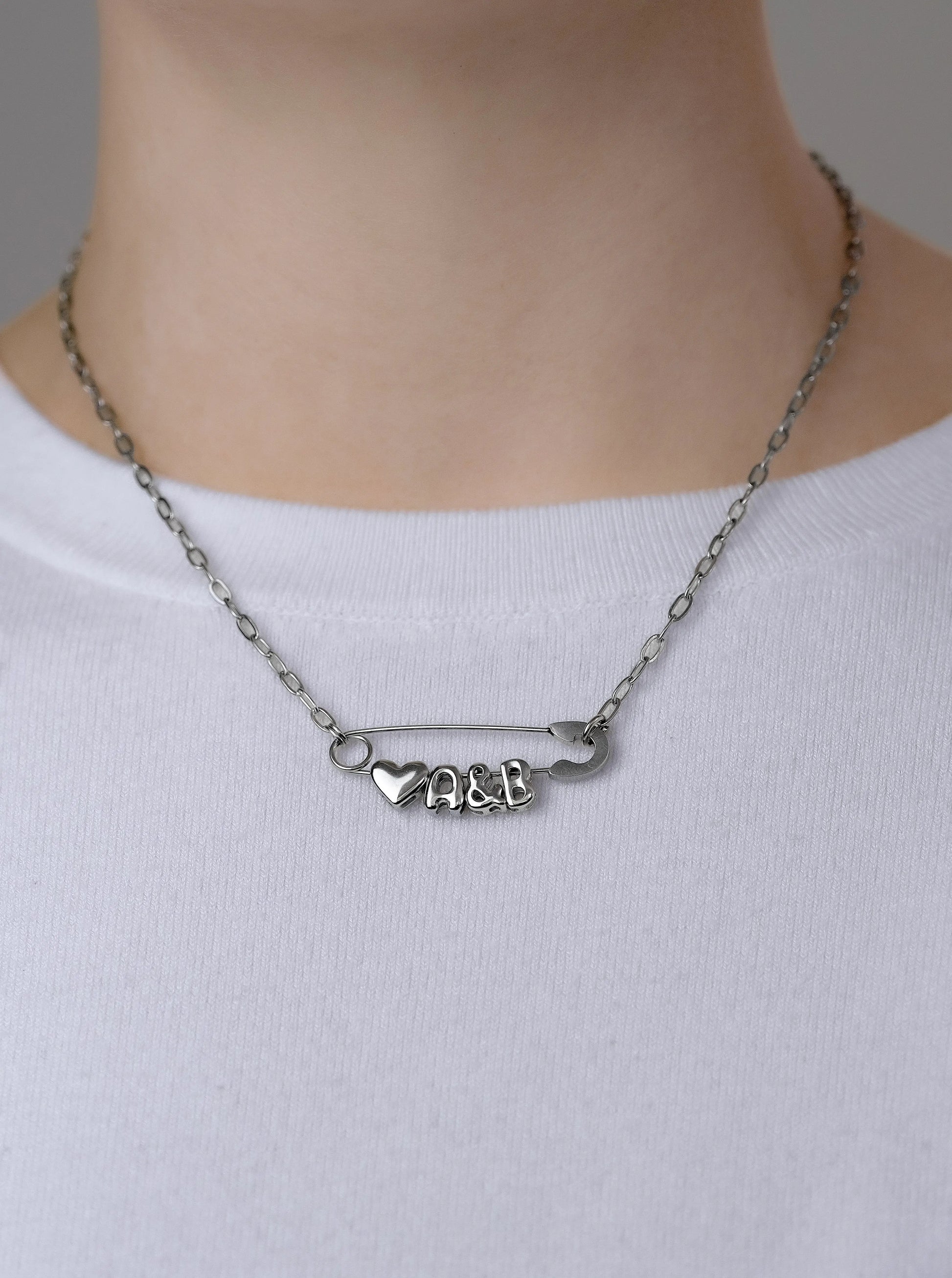 Silver safety pin couple heart necklace Leftbians