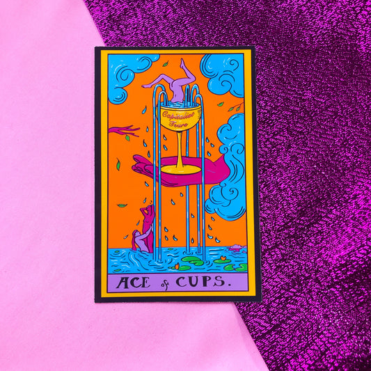 Tarot card sticker based on the Ace Of Cups. Original artwork, a pink hand holds a gold wine glass with water flowing out into the river below where there are naked people dancing in the river. The cup reads Capitalist Tears.