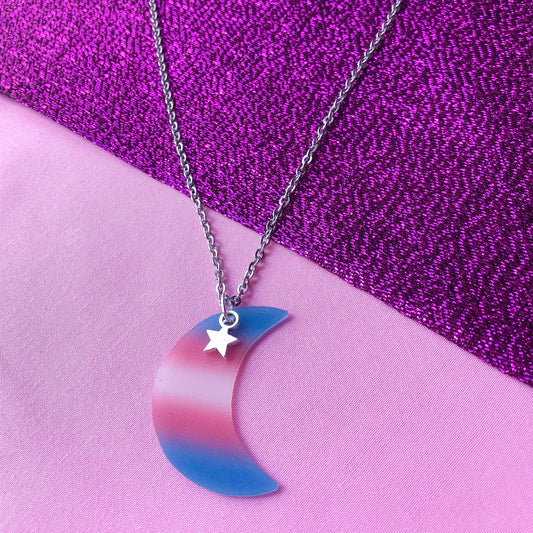 Transgender flag colours on a crescent moon charm attached to a stainless steel necklace chain