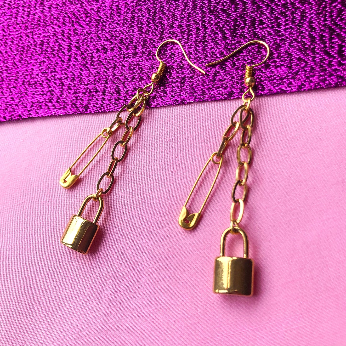 Gold locket and safety pin chain earrings